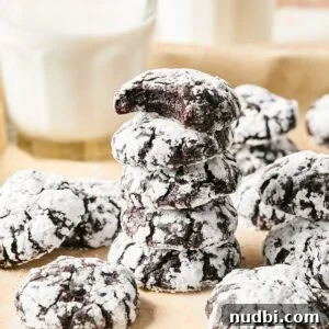 Top Christmas Cookie Recipes to Bake This Holiday Season 6 Stack of chocolate crinkle cookies with milk glass.