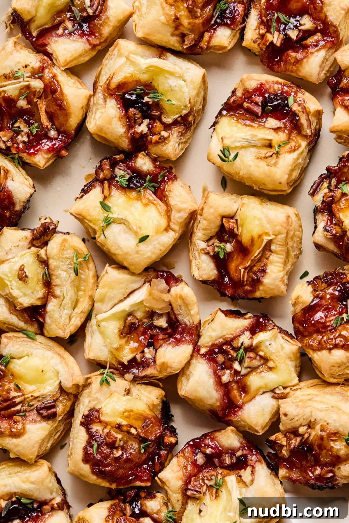 Melted Brie Puff Pastry Bites with Honey & Thyme 8 Overhead view of puff pastry brie bites on dish.