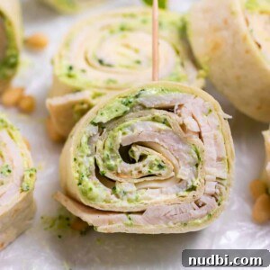 Festive Holiday Appetizers and Party Snacks Guide 12 Turkey Pesto pinwheel with toothpick.