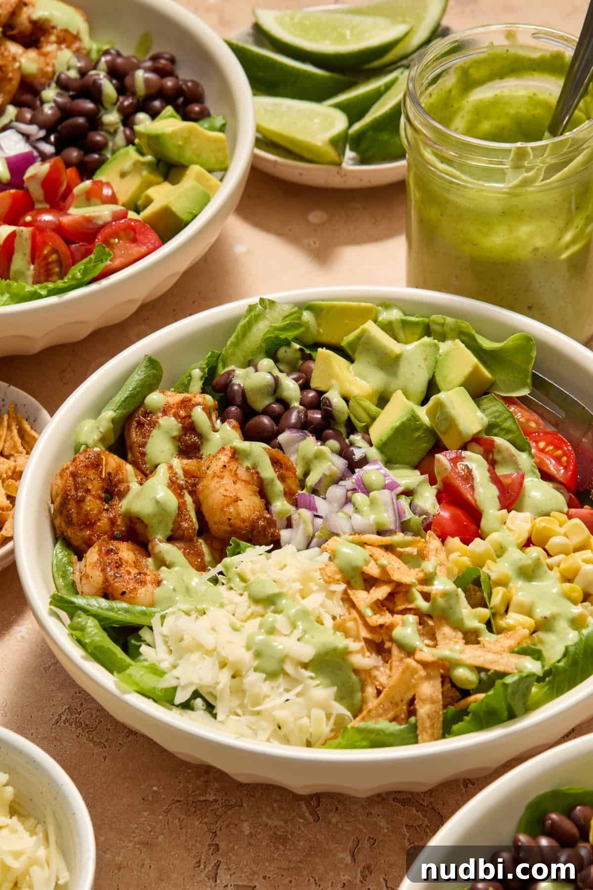 Shrimp Taco Salad with Creamy Cilantro-Lime Dressing 11 Shrimp taco salad prepared in bowl with dressing drizzled over top.