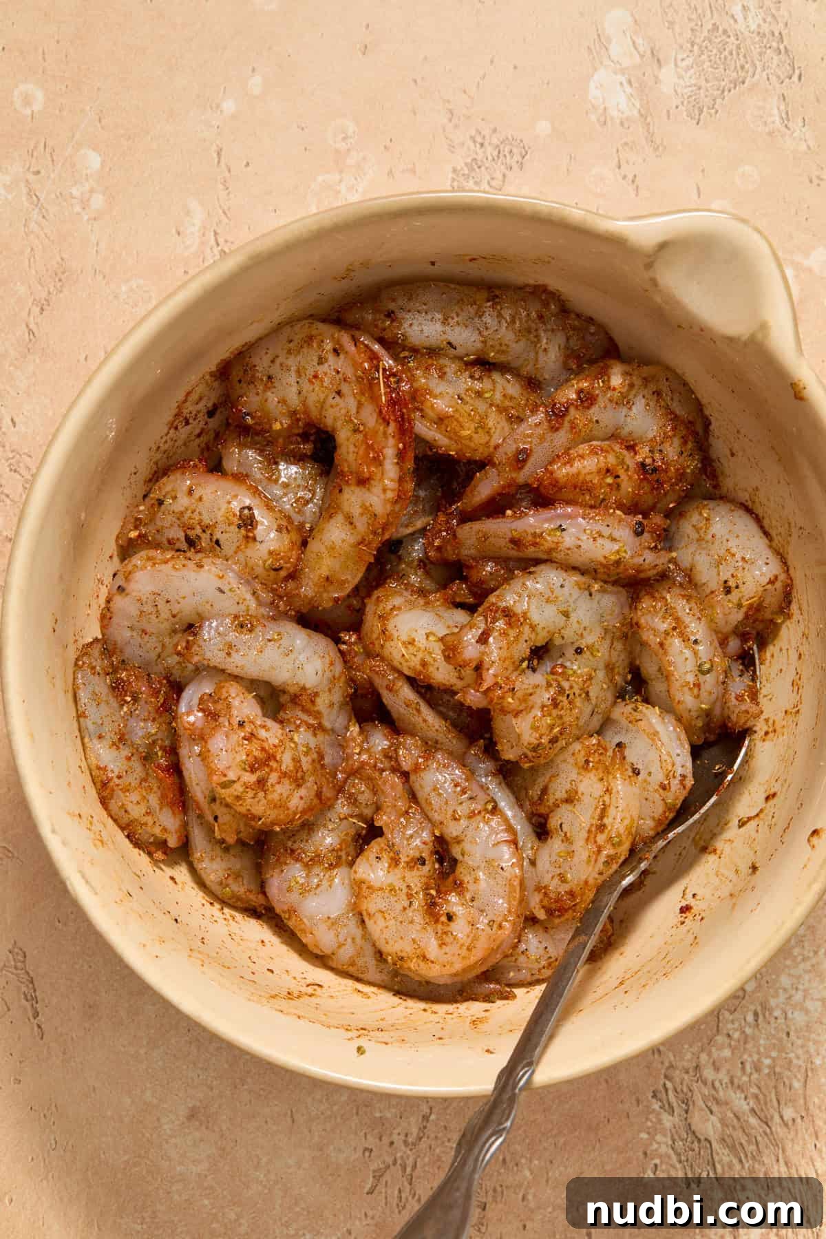 Shrimp Taco Salad with Creamy Cilantro-Lime Dressing 5 Seasoned shrimp in mixing bowl with spoon.