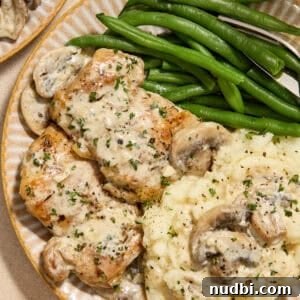 30-Minute Dinner Recipes You'll Love 21 Plate with creamy chicken thighs and mushrooms with mashed potatoes and green beans.