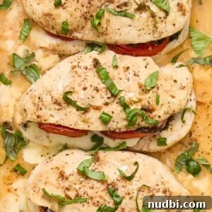 30-Minute Dinner Recipes You'll Love 22 Close up view of stuffed chicken breasts topped with freshly chopped basil.
