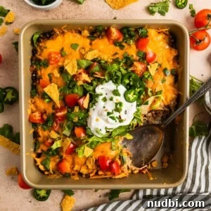 30-Minute Dinner Recipes You'll Love 4 Chicken taco bake in pan with serving spoon scooping in.