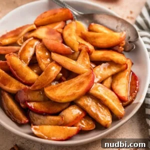 Crispy Caramelized Apples in the Air Fryer 10 Plate with cinnamon sugar apples and serving utensil.