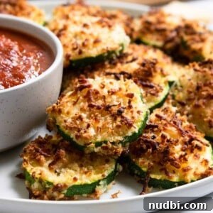 Zucchini with crispy cheese coating on plate.