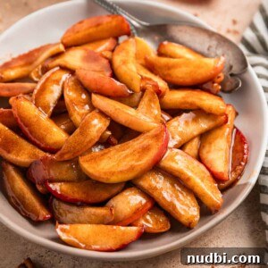 Plate with cinnamon sugar apples and serving utensil.