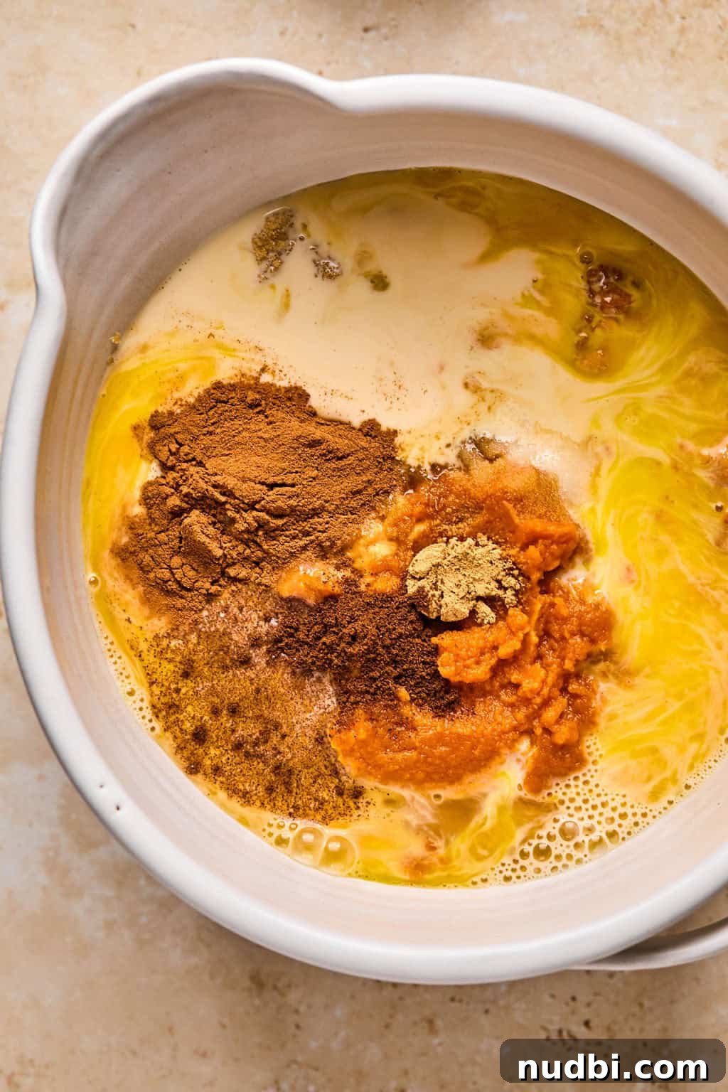 Ultimate Pumpkin Pie Crumble Recipe with a Buttery Streusel Topping 5 Pumpkin, butter, evaporated milk, sugar, and other ingredients in bowl before mixing.