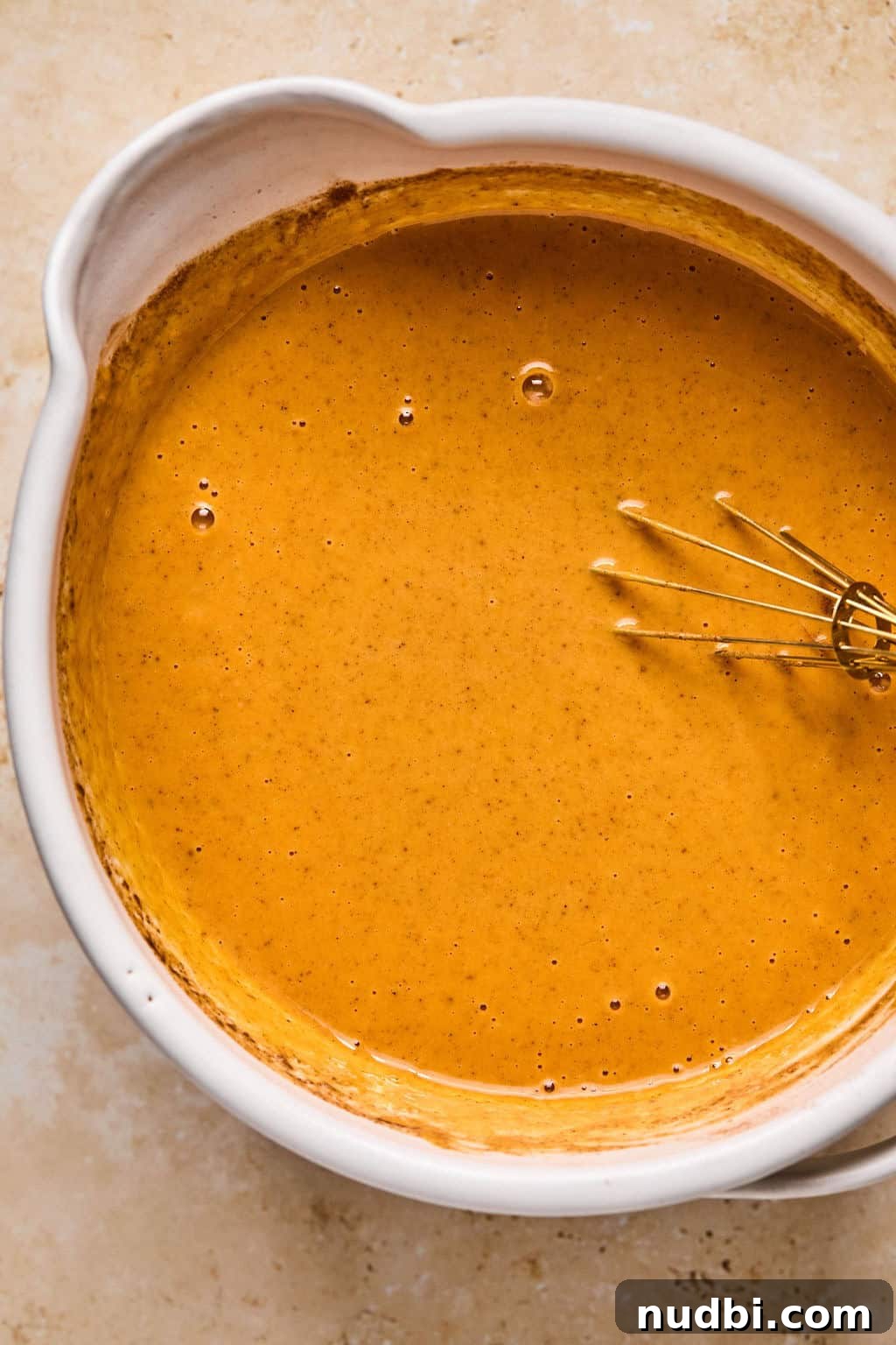 Ultimate Pumpkin Pie Crumble Recipe with a Buttery Streusel Topping 6 Pumpkin pie mixture in bowl with whisk.