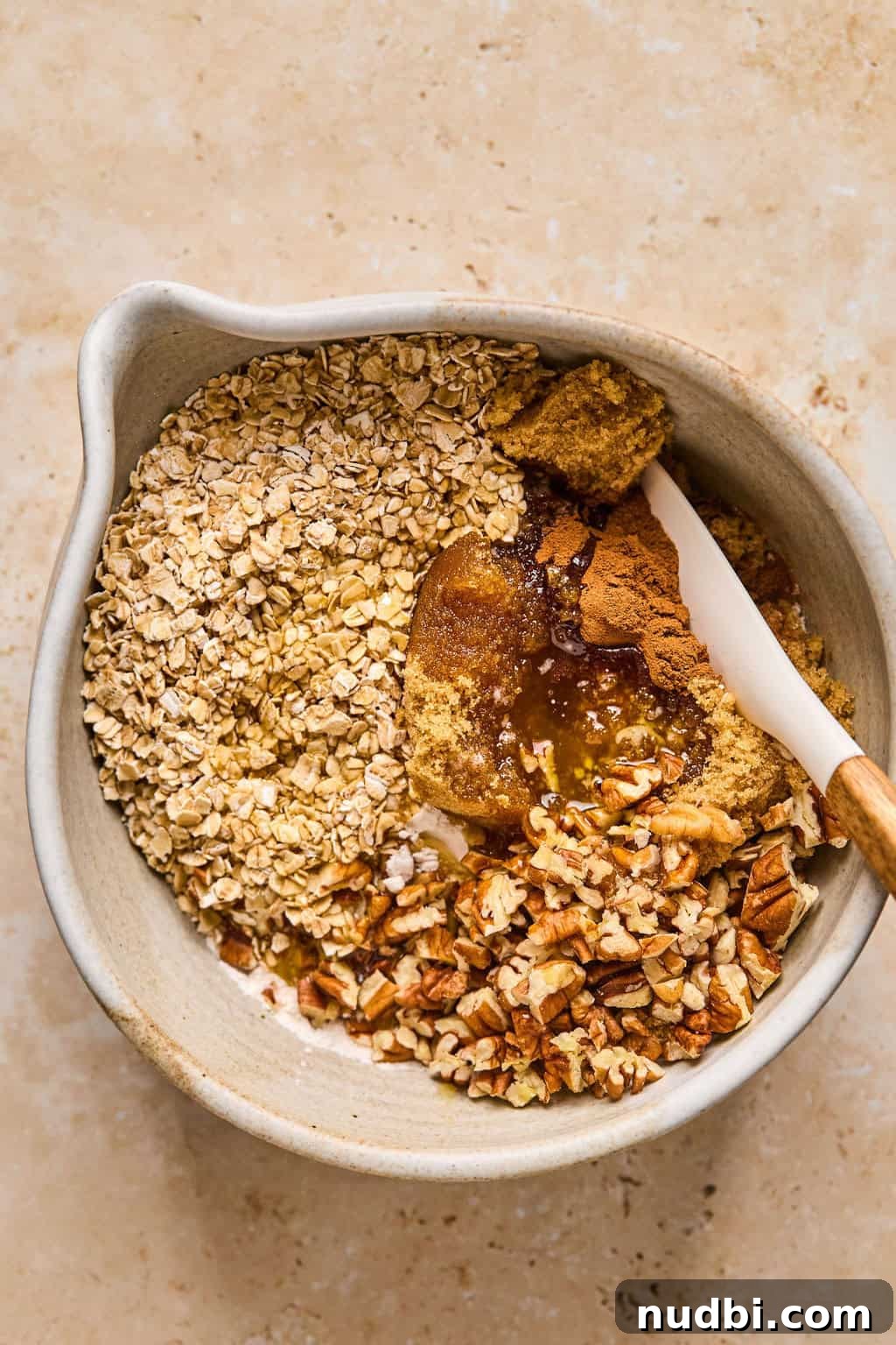 Ultimate Pumpkin Pie Crumble Recipe with a Buttery Streusel Topping 7 Crumble or crisp topping ingredients in mixing bowl with spoon.