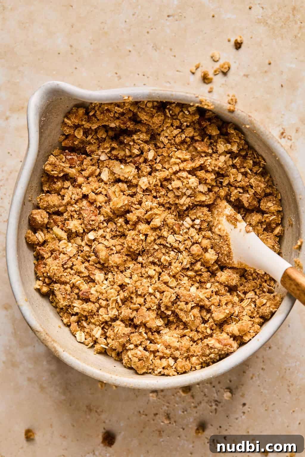 Ultimate Pumpkin Pie Crumble Recipe with a Buttery Streusel Topping 8 Prepared oat crumble topping in bowl before baking.