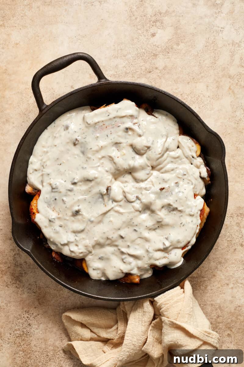 Creamy Mushroom Pork Chops with Garlic and Thyme 11 Cream of mushroom soup over pork chops and mushrooms in skillet.