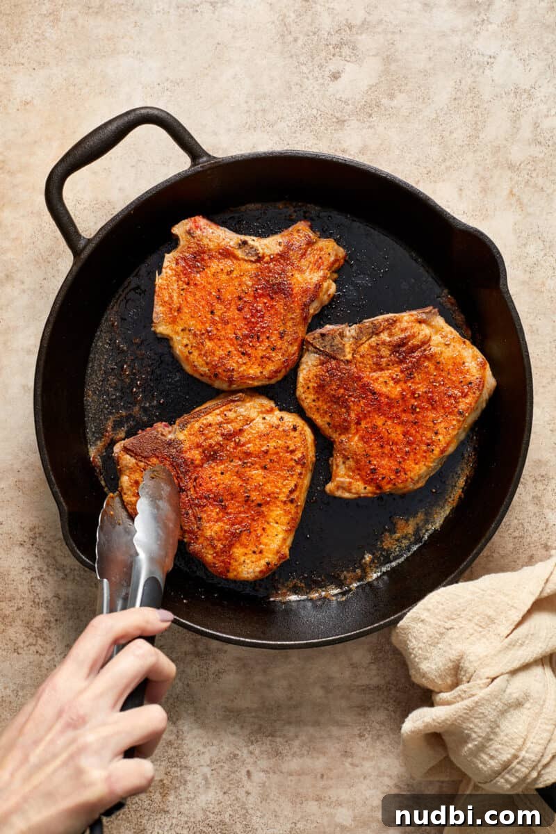 Creamy Mushroom Pork Chops with Garlic and Thyme 9 Browned pork chops in skillet.