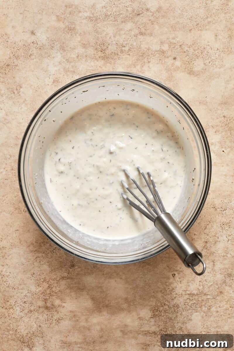 Creamy Mushroom Pork Chops with Garlic and Thyme 10 Cream of mushroom mixture in bowl with whisk.