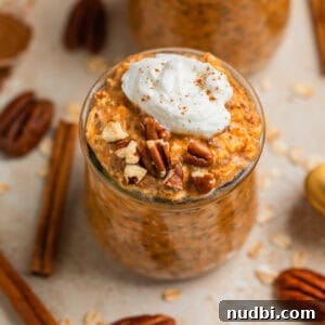 Creamy Overnight Oats Recipes for Quick Healthy Breakfasts 12 Pumpkin pie overnight oats in jar topped with whipped cream and cinnamon and pecans.
