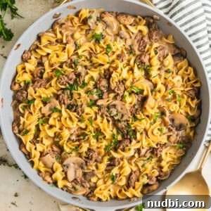 Cozy Dinner Recipes for Comforting Weeknight Meals 12 Skillet with beef stroganoff topped with chopped fresh parsley.