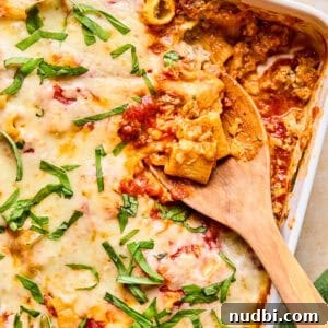 Cozy Dinner Recipes for Comforting Weeknight Meals 16 Pasta bake with Italian sausage in pan with spoon scooping in.
