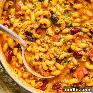 Cozy Dinner Recipes for Comforting Weeknight Meals 8 Ladle scooping up chili macaroni and cheese in pot.