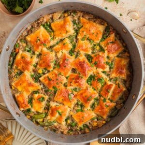 Cozy Dinner Recipes for Comforting Weeknight Meals 10 Ground turkey pot pie in pan with pieces of puff pastry over top.