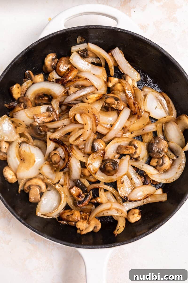 French Dip Sliders Recipe with Savory Au Jus for Dipping 4 Caramelized onions and mushrooms in skillet.