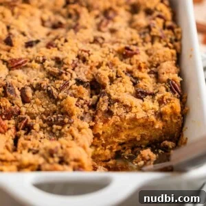 Casserole dish with baked brioche French toast casserole topped with pecan streusel.