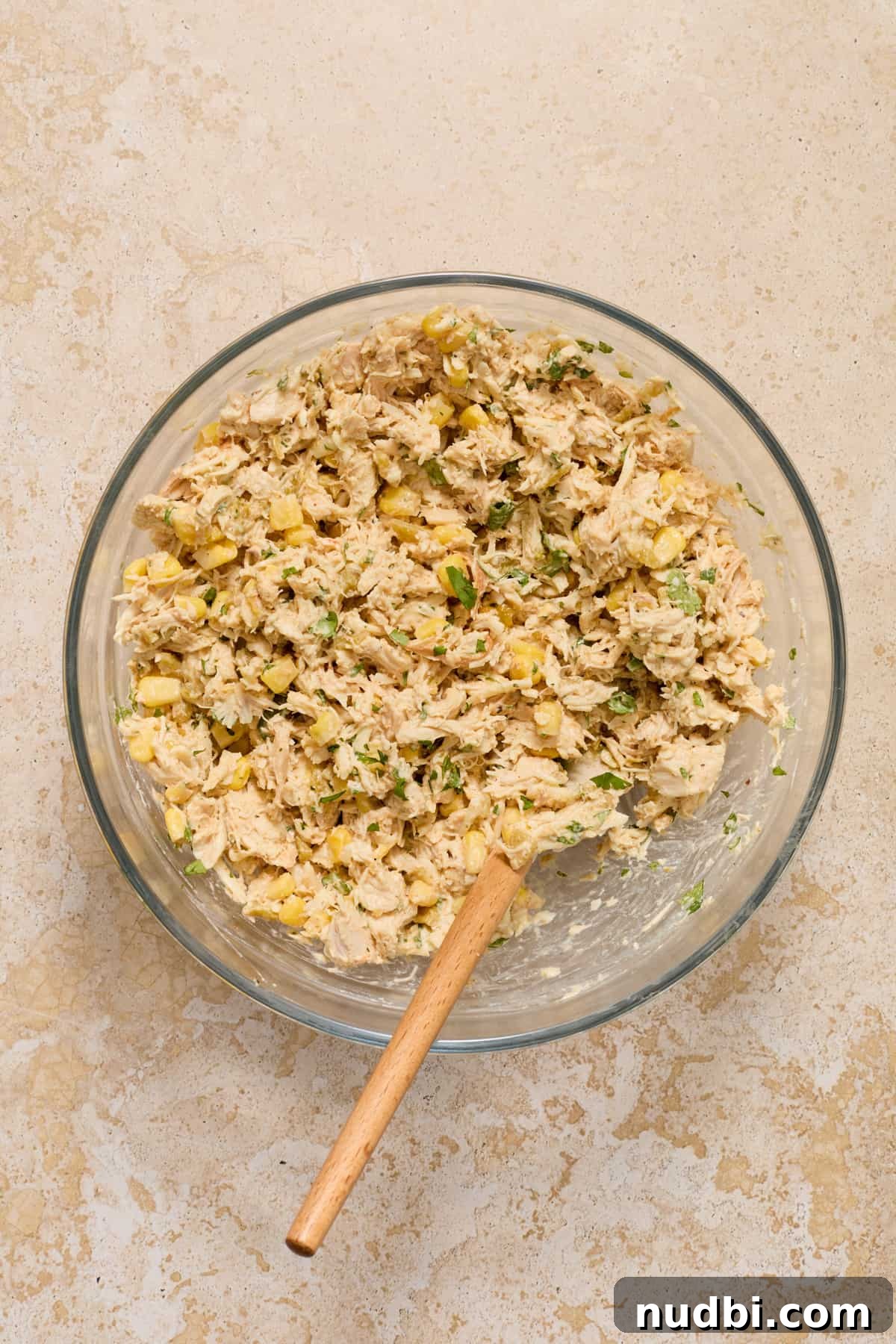 Authentic Green Salsa Chicken Enchiladas Recipe 5 Chicken enchiladas mixture in glass mixing bowl.