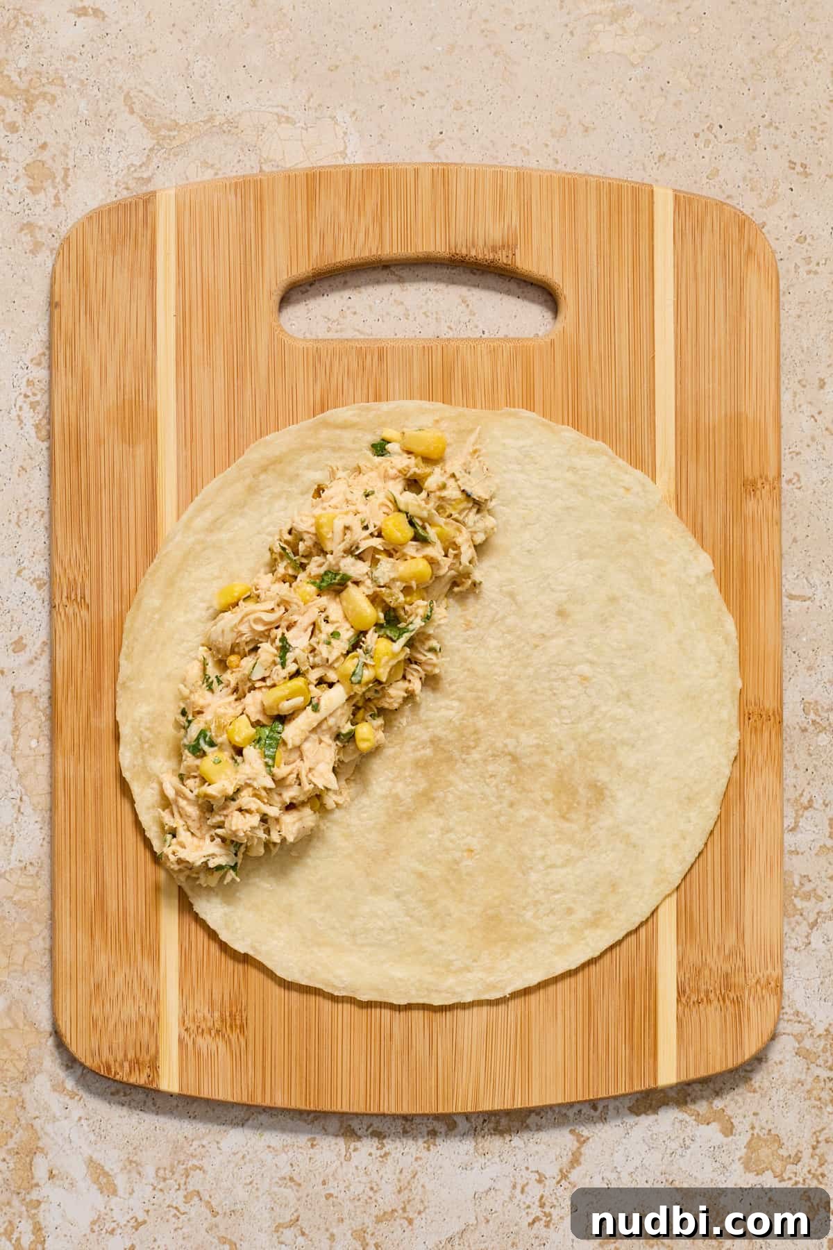 Authentic Green Salsa Chicken Enchiladas Recipe 6 Chicken enchilada mixture on tortilla.