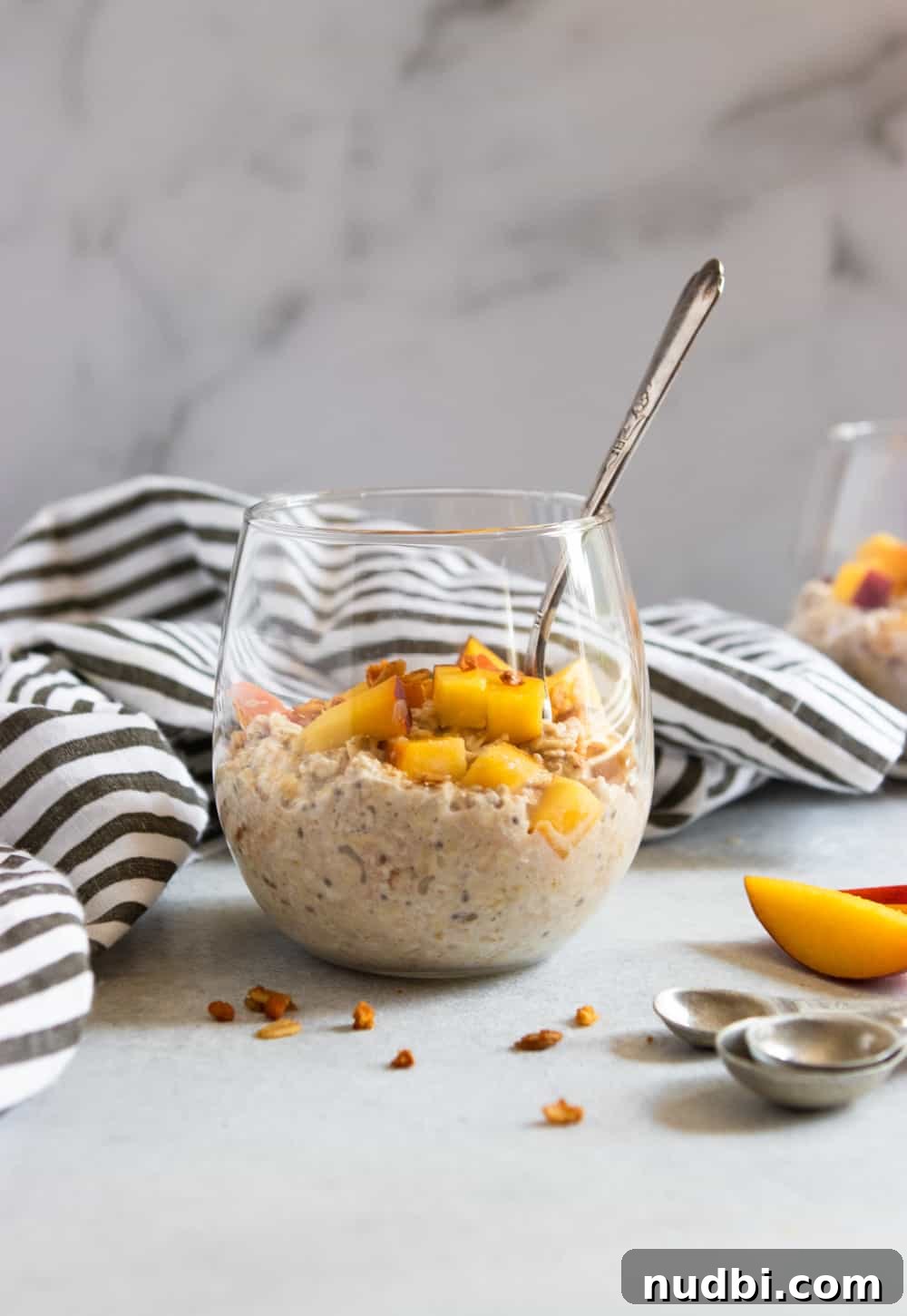 Peach Pie Overnight Oats Recipe for Quick Morning Meals 3 Oatmeal in glass with granola and fresh fruit.