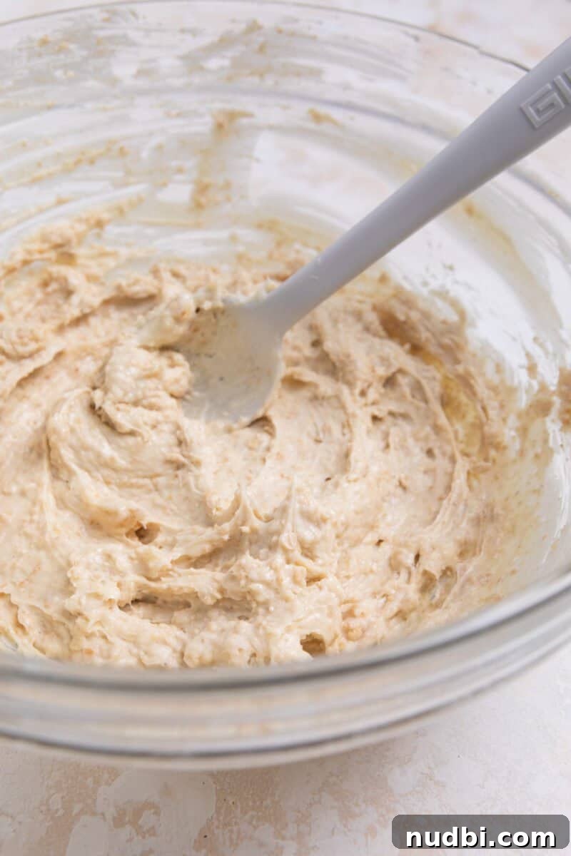 No-Bake Mini Cheesecake Bites: Easy Dessert Balls Recipe 6 No bake cheesecake ball mixture stirred in bowl.