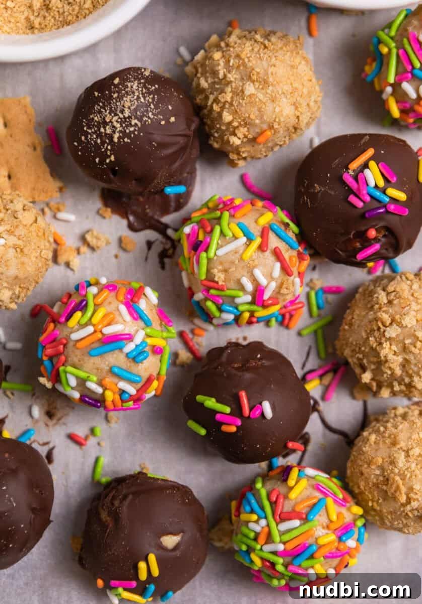 No-Bake Mini Cheesecake Bites: Easy Dessert Balls Recipe 9 Variety of coated no bake cheesecake balls on parchment with sprinkles, graham cracker crumbs and chocolate.