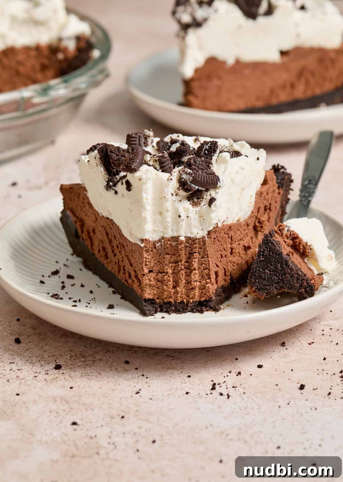 No-Bake Chocolate Cream Pie Recipe for Rich, No-Fuss Dessert 2 Slice of no bake chocolate cream pie on white plate with forkful taken out.