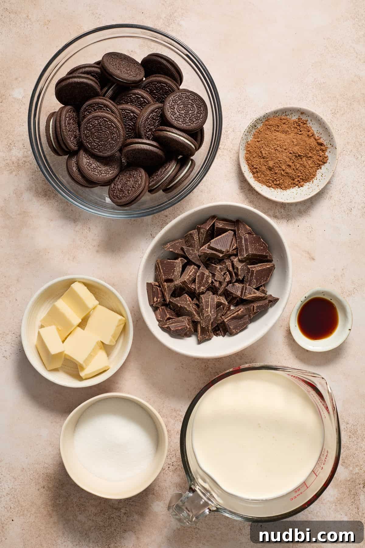 No-Bake Chocolate Cream Pie Recipe for Rich, No-Fuss Dessert 4 Oreo cookies, cocoa powder, heavy cream, butter and other ingredients arranged on surface.