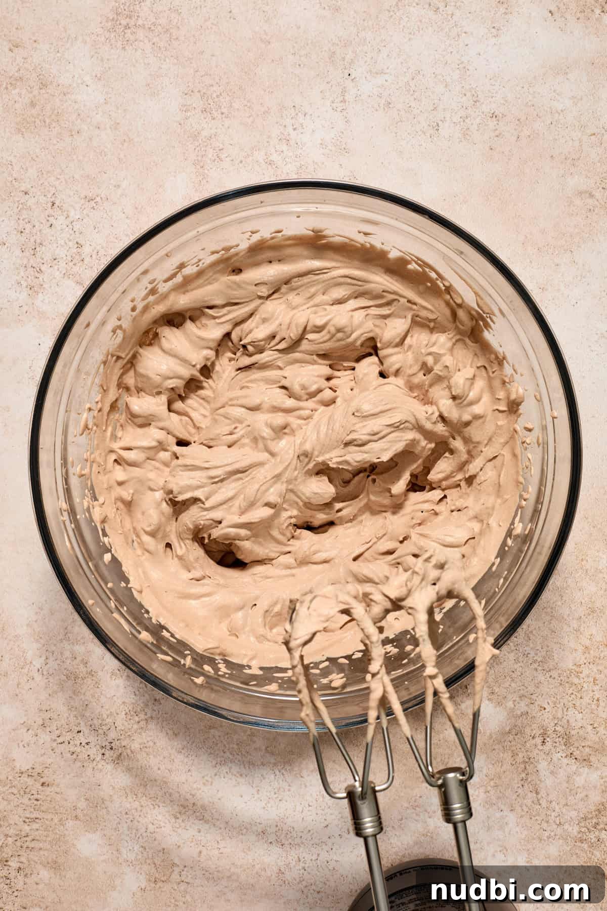 No-Bake Chocolate Cream Pie Recipe for Rich, No-Fuss Dessert 10 Chocolate whipped cream in glass bowl with electric beaters.