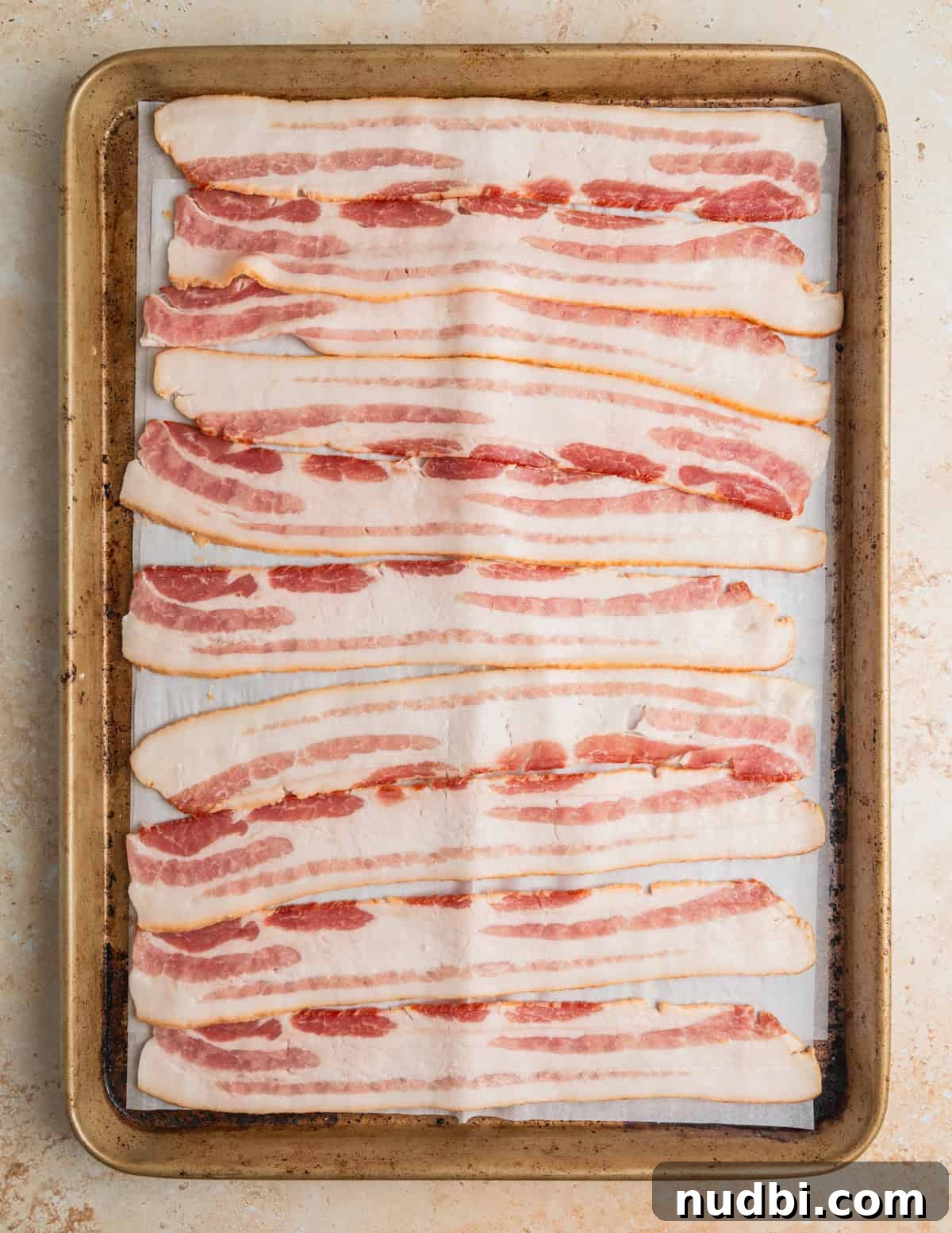 Chicken, Bacon & Ranch Pasta Salad Recipe for Summer Meals 3 Uncooked bacon on sheetpan lined with parchment.