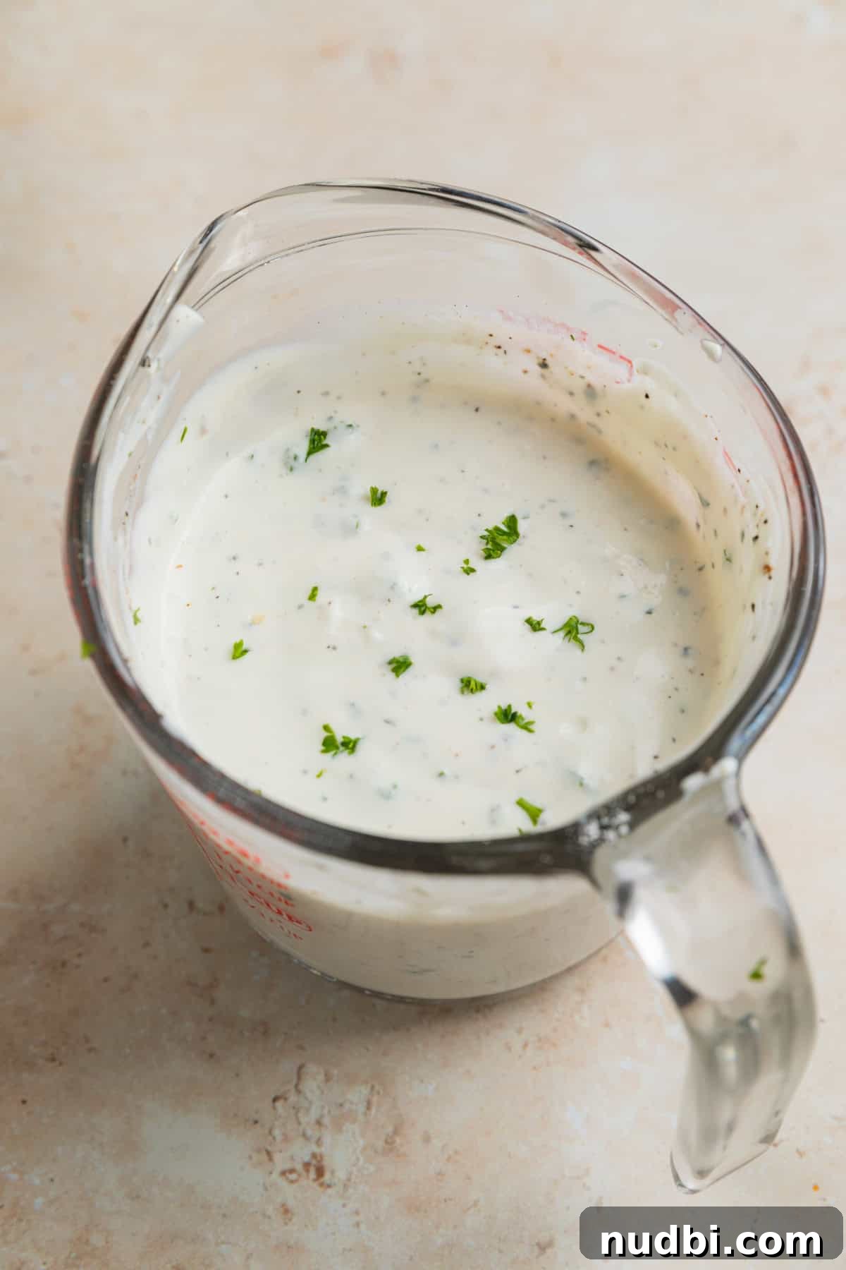 Chicken, Bacon & Ranch Pasta Salad Recipe for Summer Meals 5 Homemade ranch dressing in measuring glass.