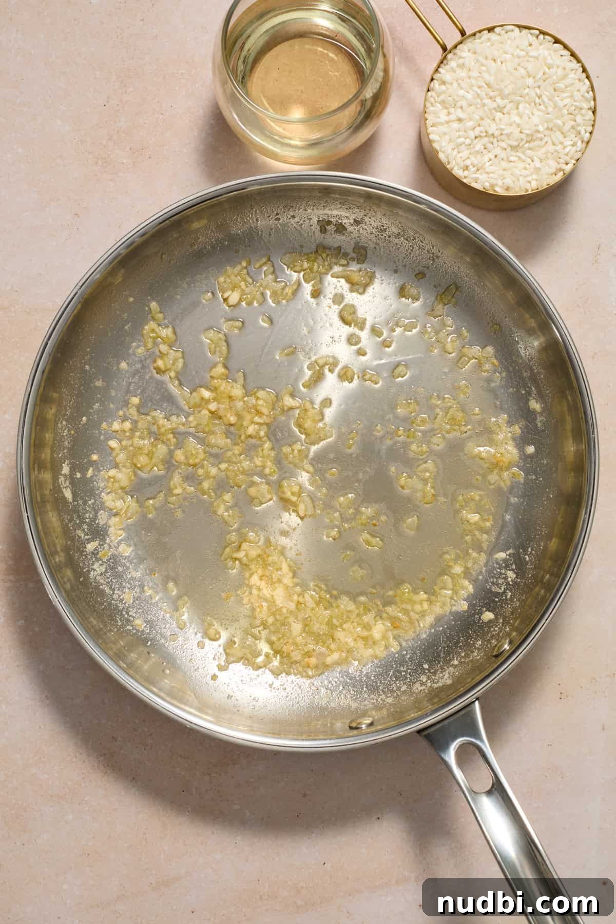Creamy Spring Risotto with Peas and Asparagus 6 Butter and garlic sautéed in skillet.