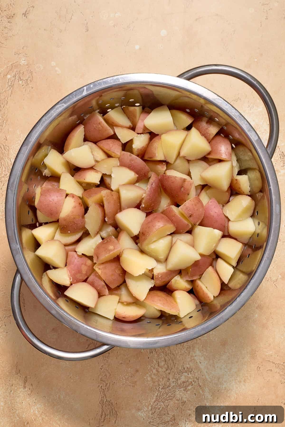 Cajun Potato Salad Recipe with Zesty Dressing and Bacon 4 Potatoes cooked in pot.