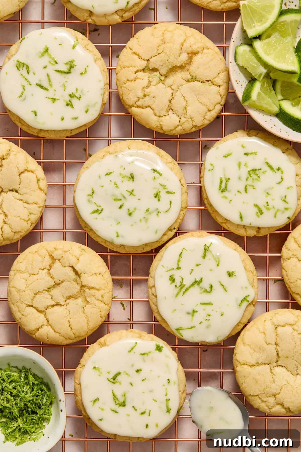 Zesty Key Lime Cookie Recipe for Luscious Citrus Cookies 10 Cookies on cooling rack with icing on spoon and some cookies iced and others not.