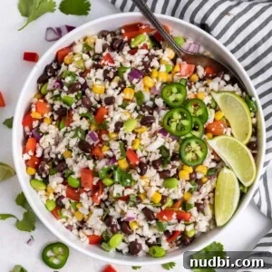 Side Dishes to Serve with Carnitas: 15 Flavor-Packed Pairings 11 White salad bowl with cauliflower rice salad with serving spoon.