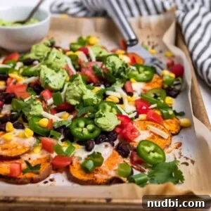Side Dishes to Serve with Carnitas: 15 Flavor-Packed Pairings 6 Sheet pan with sweet potato nachos covered with corn, beans, jalapeño, cheese, cilantro and avocado crema.