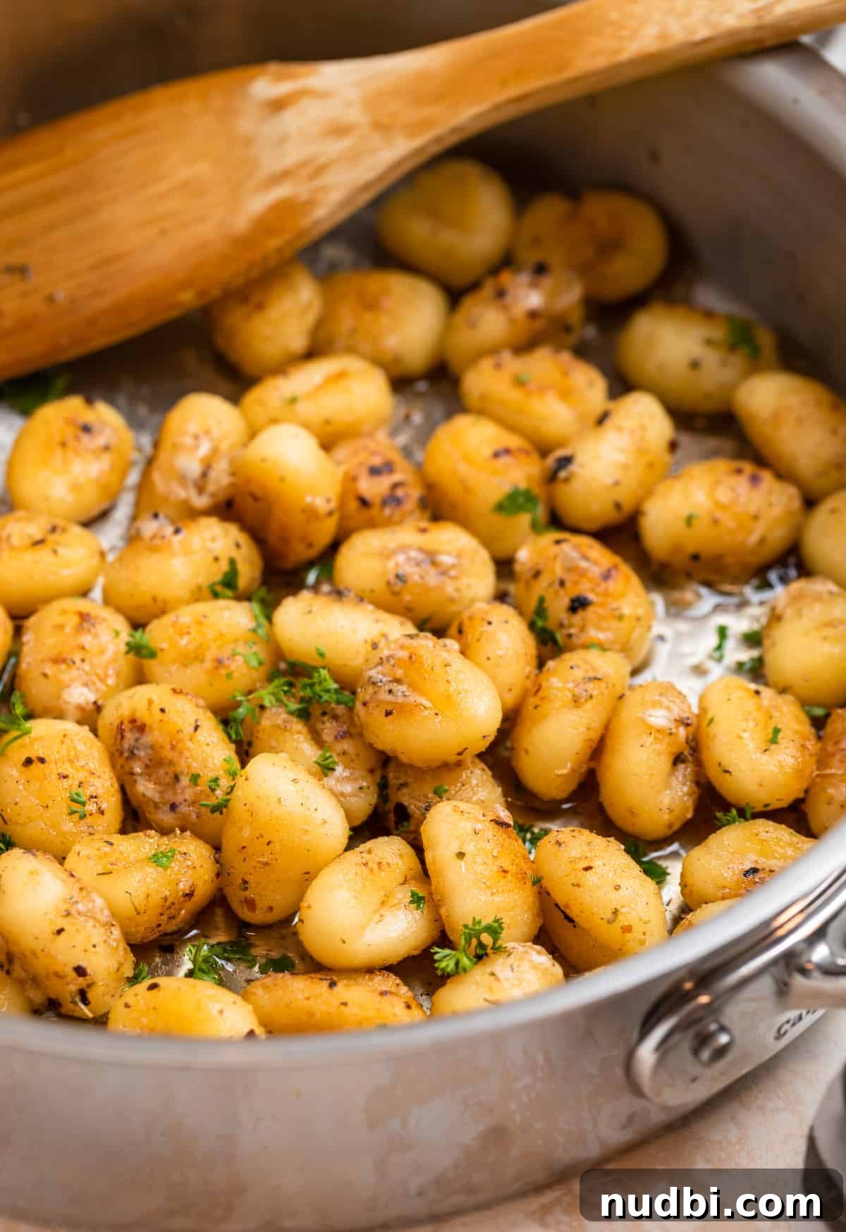 10 Delicious Side Dishes to Serve With Gnocchi 2 Gnocchi in skillet with parmesan, butter, chopped parsley.