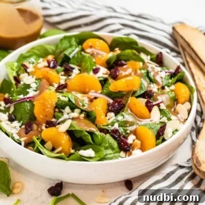 10 Delicious Side Dishes to Serve With Gnocchi 11 White salad bowl with spinach, cranberries, almonds, goat cheese, oranges and balsamic dressing drizzled on top.