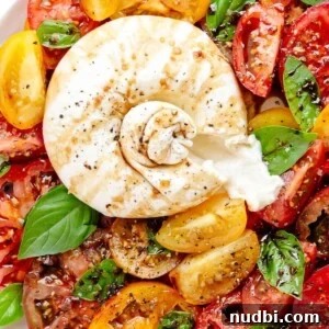 10 Delicious Side Dishes to Serve With Gnocchi 8 Burrata and tomatoes on plate with basil and balsamic.