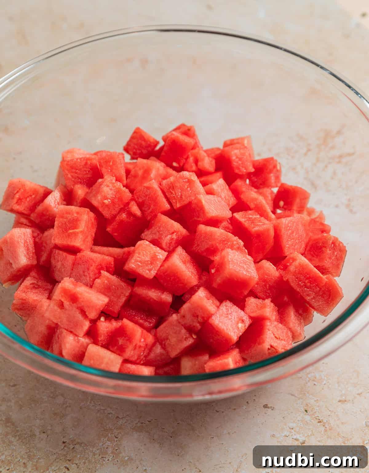Watermelon and Avocado Salad with Feta and Mint 4 Cubed watermelon in glass bowl.