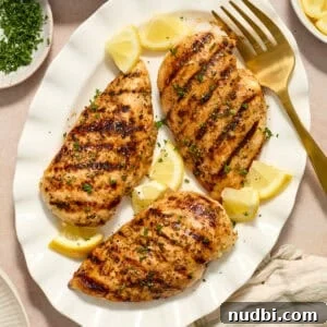 Lemon Pepper Grilled Chicken Recipe – Zesty Weeknight Dinner 11 Grilled lemon pepper chicken on white serving platter with lemon wedges.