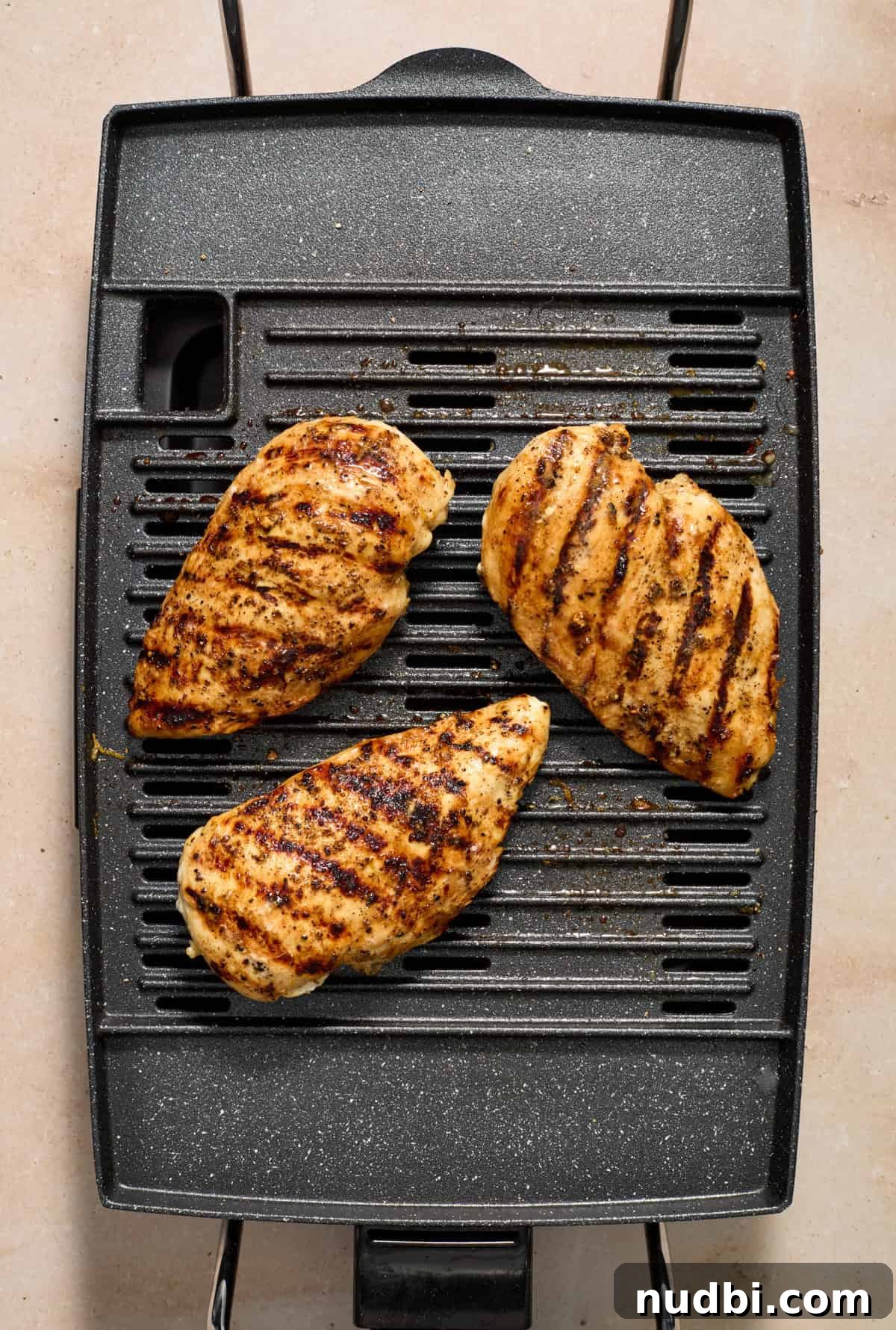 Lemon Pepper Grilled Chicken Recipe – Zesty Weeknight Dinner 8 Indoor grill with lemon pepper chicken grilling.