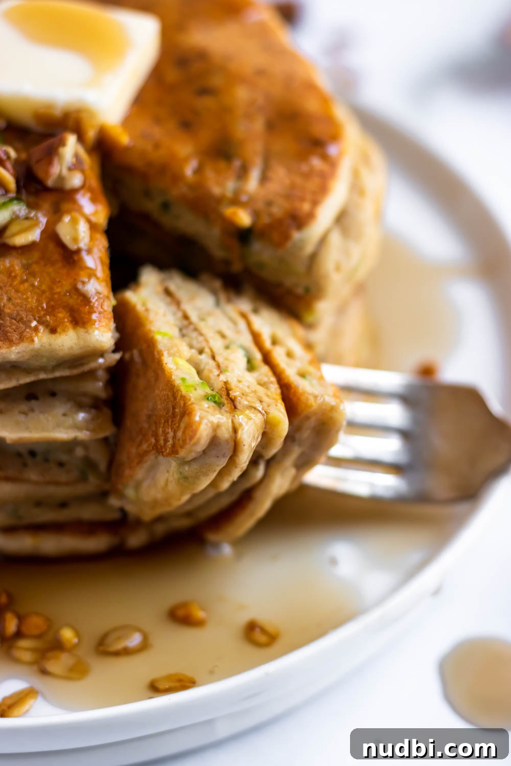 Zucchini Pancakes with Oat Flour — Light, Fluffy & Gluten-Friendly 3 Fork in pancakes with zucchini.
