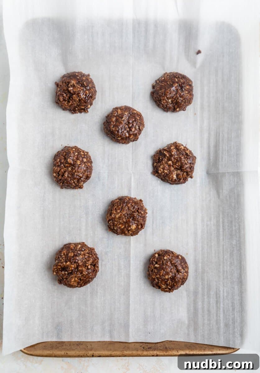 No-Bake Cookie Butter Sandwich Cookies 8 Cookie butter cookies spooned on parchment lined cookie sheet.