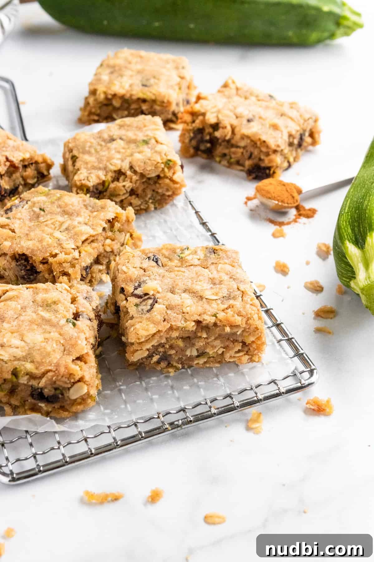Zucchini Oat Bars Recipe: Moist Baked Snack Bars with Oats 6 Zucchini bars on cooling rack with crumbs.