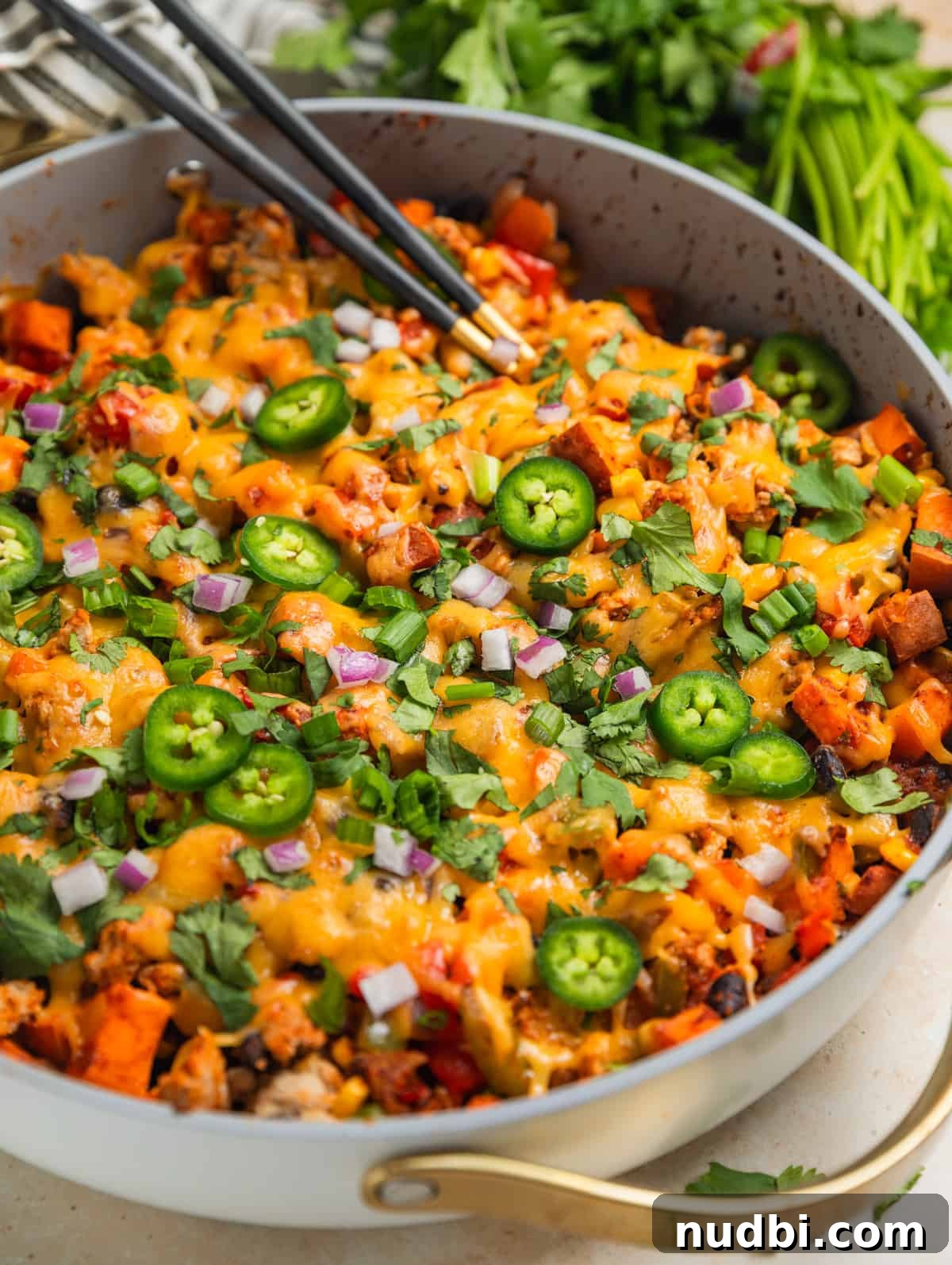 One-Pan Ground Turkey and Sweet Potato Skillet Recipe 2 Ground turkey and sweet potato skillet dinner in skillet topped with jalapeños, cilantro, onion and more.